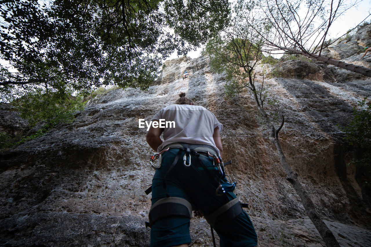 Rear view of man climbing rock