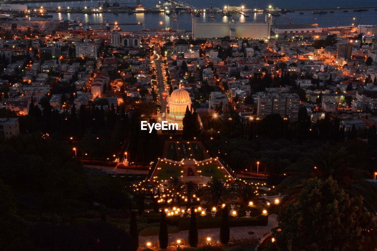 Illuminated temple and  cityscape against sky at night