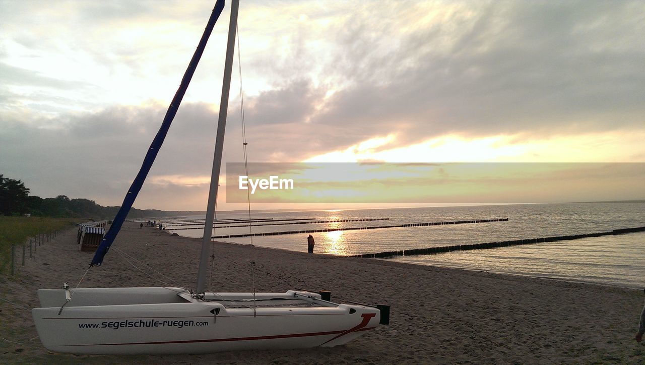 SCENIC VIEW OF SEA AGAINST CLOUDY SKY DURING SUNSET