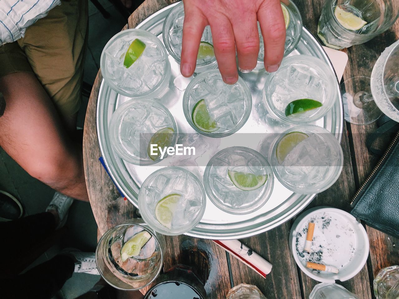 High angle view of person holding mojito in tray