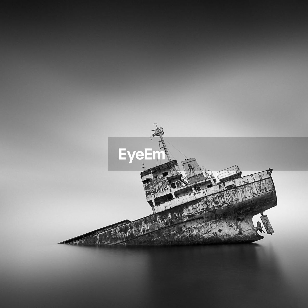 Abandoned ship in sea against sky