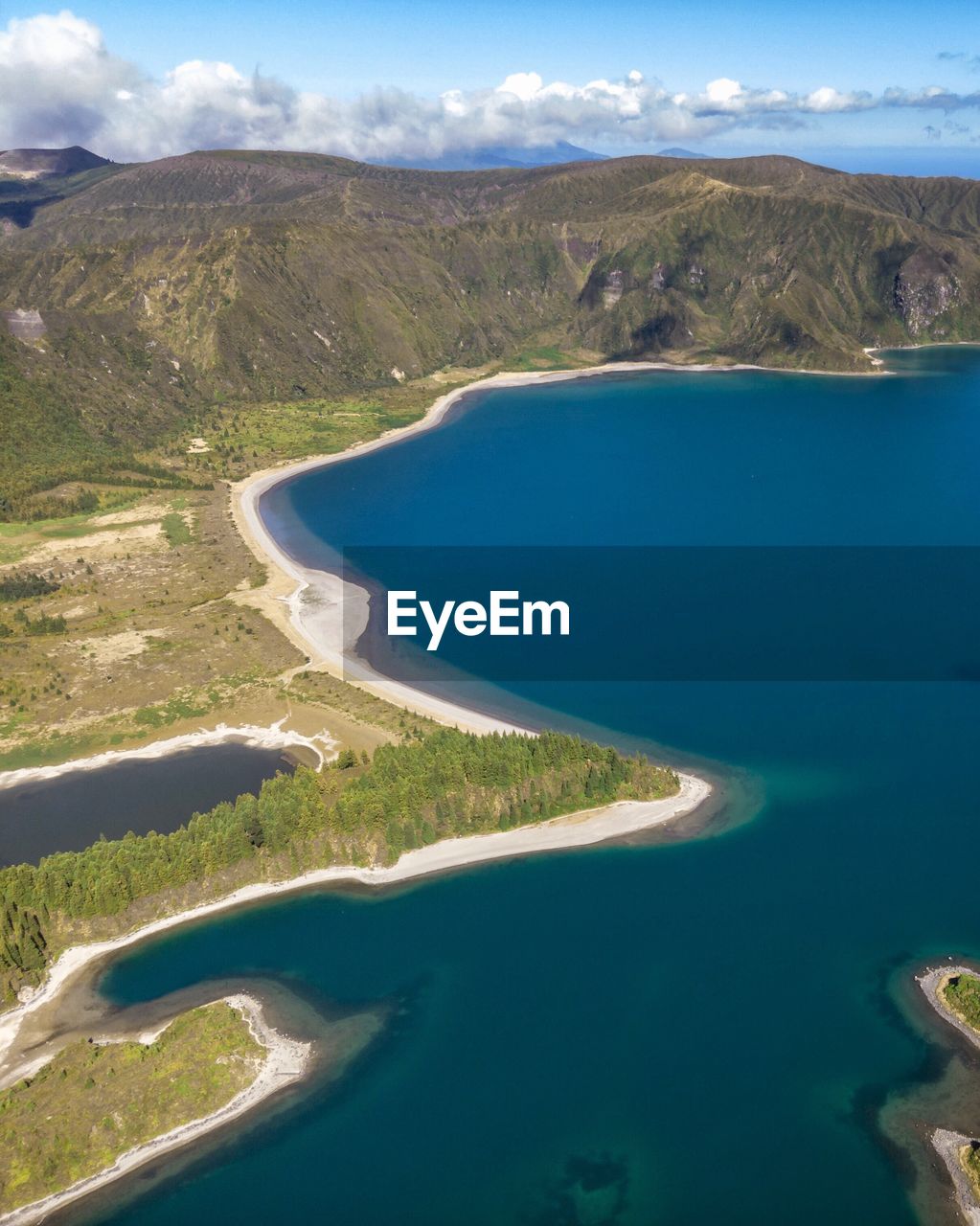 Scenic view of sea and mountains against sky