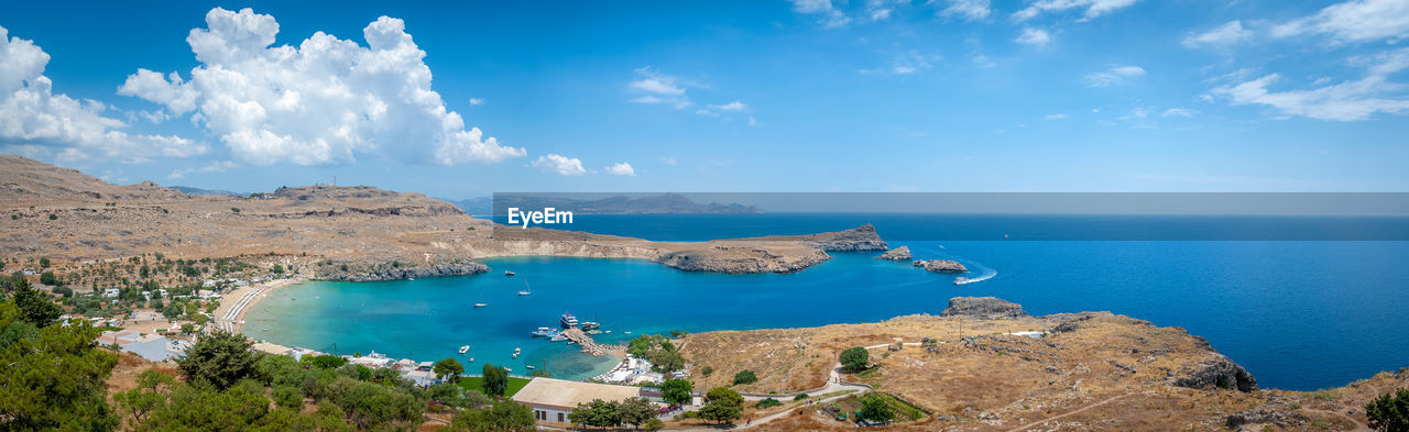 Panoramic view over local beach in an enclosed bay in lindos village. island of rhodes. greece.