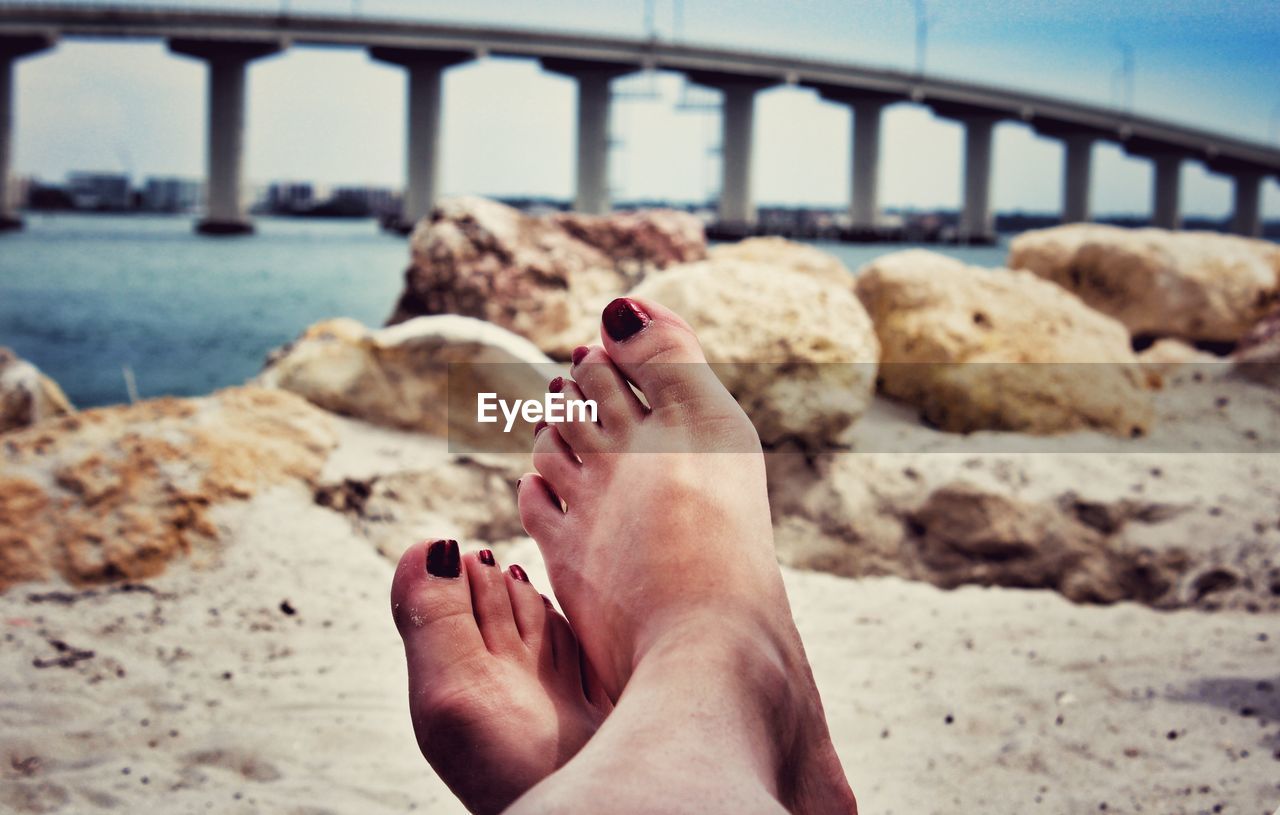 Low section of woman legs on beach