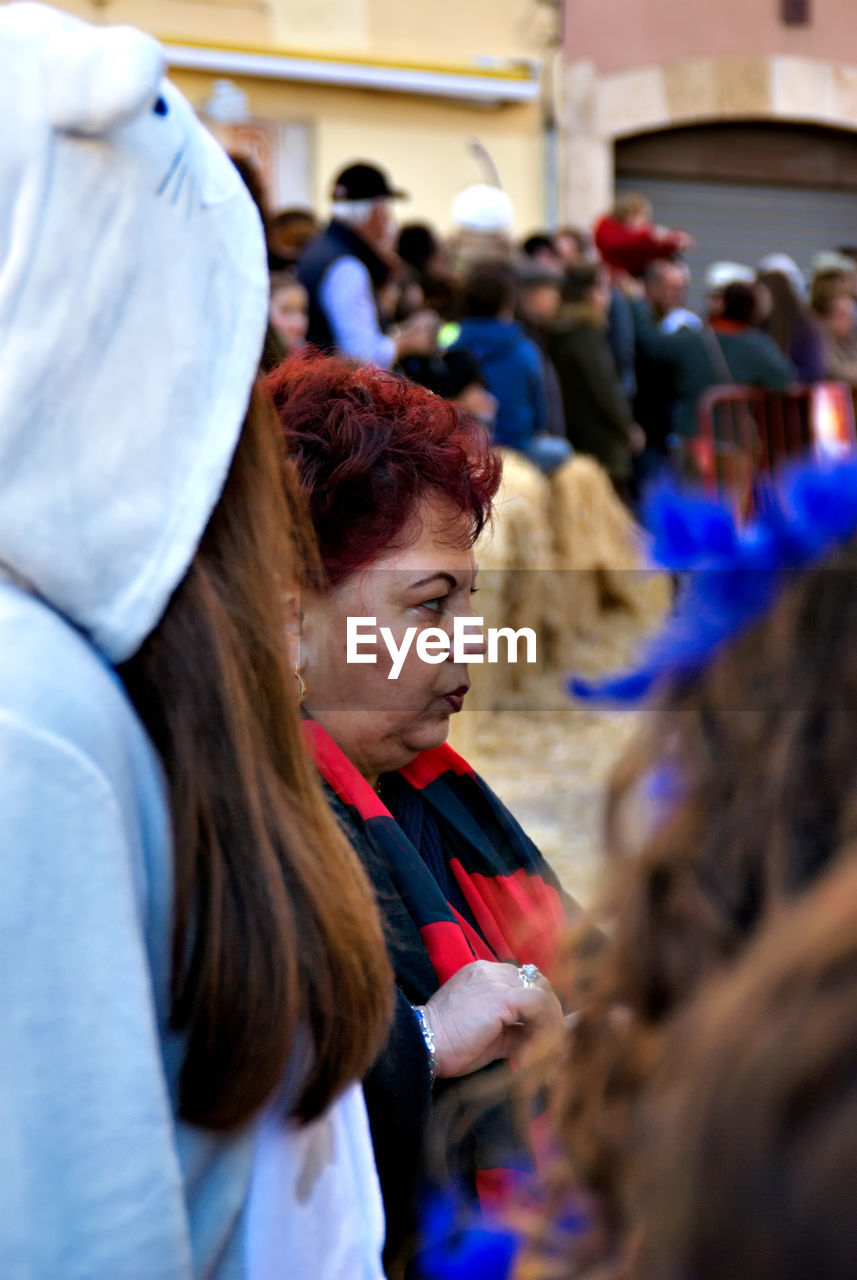 Side view of senior woman standing during event