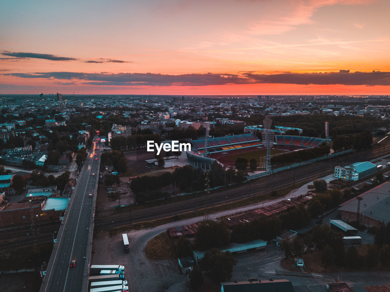 HIGH ANGLE VIEW OF CITYSCAPE DURING SUNSET