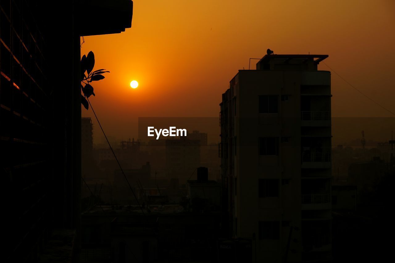 Silhouette of city at sunset