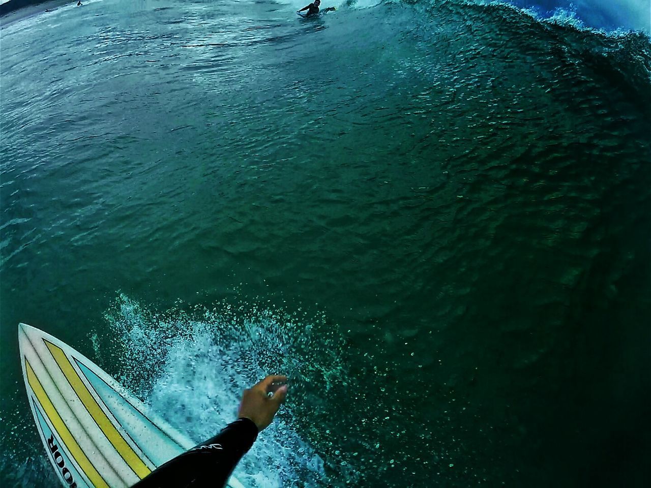 Cropped image of person surfing in sea