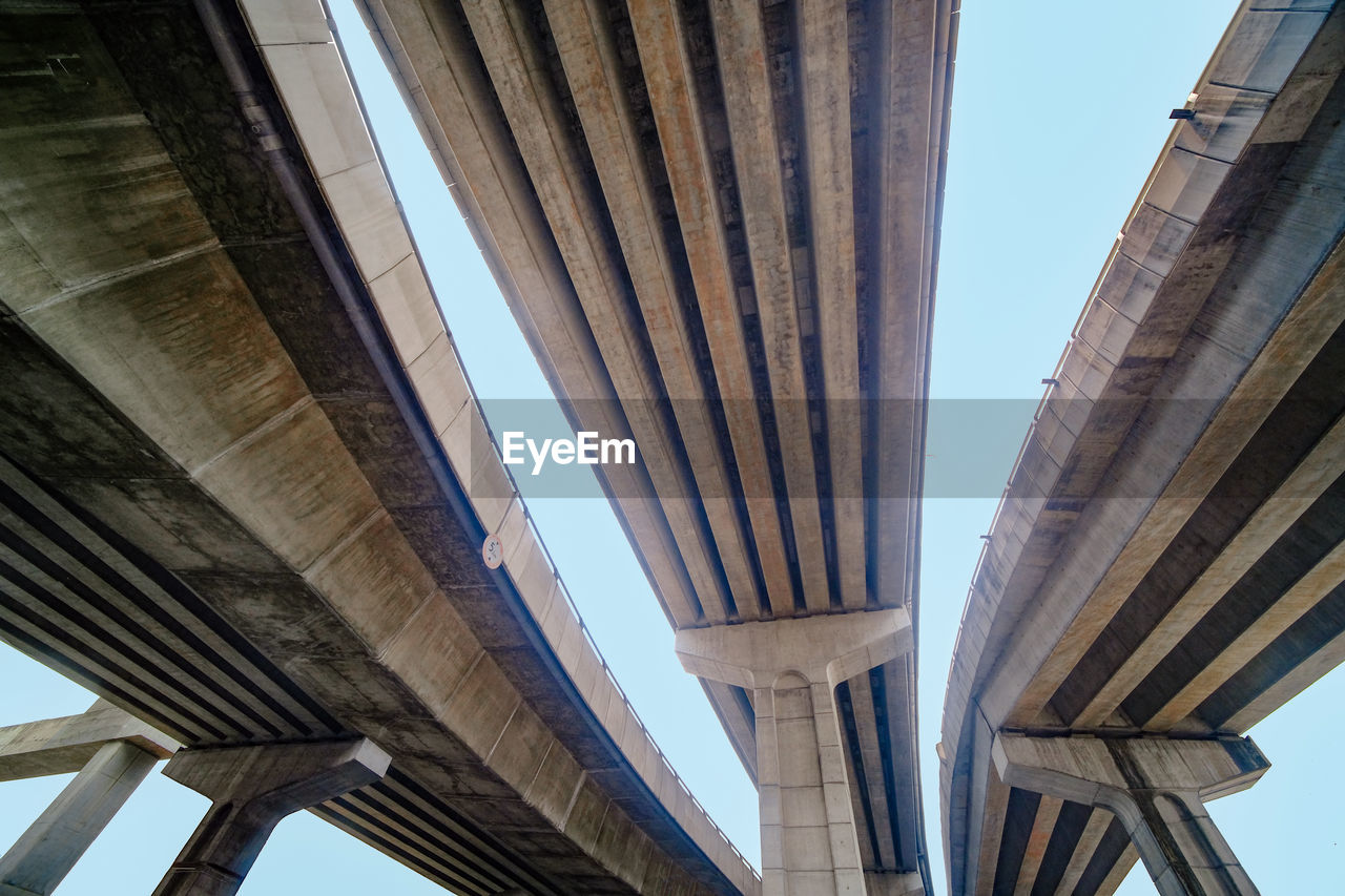 Low angle view of concrete bridges against a clear sky