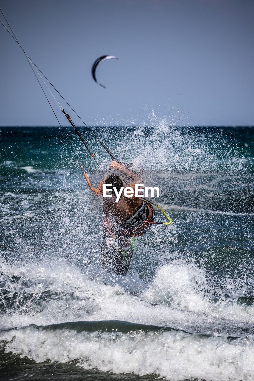 PERSON SPLASHING WATER IN SEA