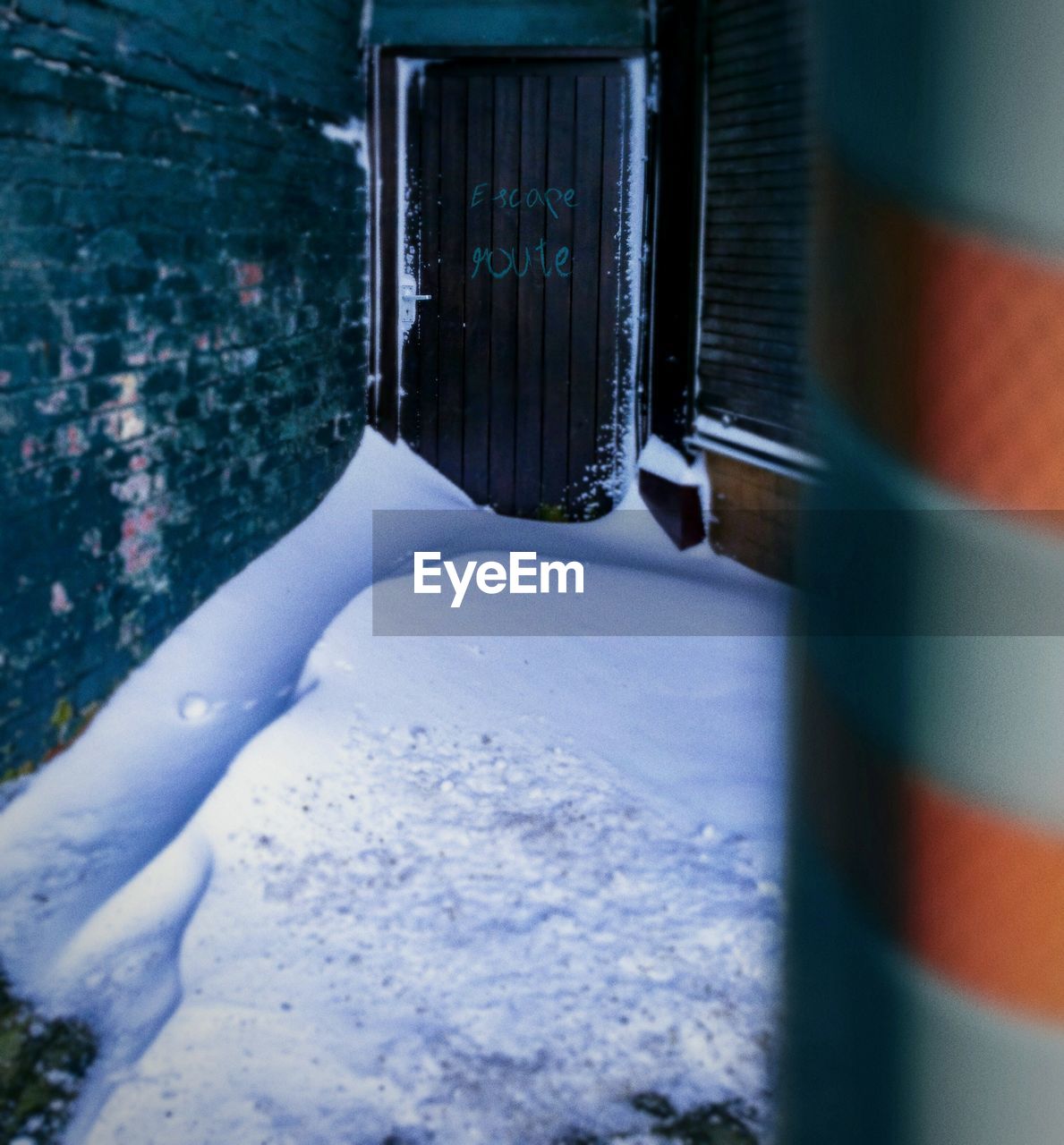 Close-up of snow by escape door