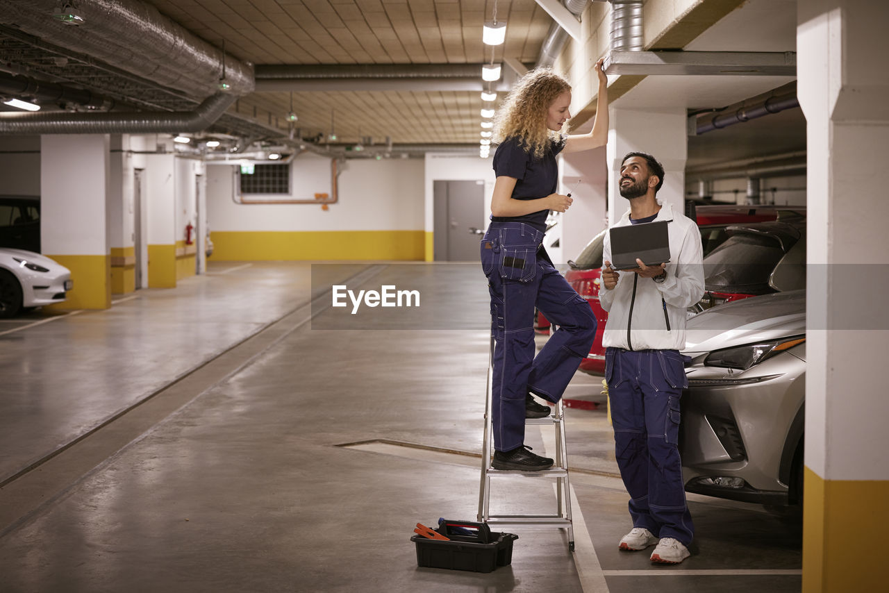 Man and woman checking air duct