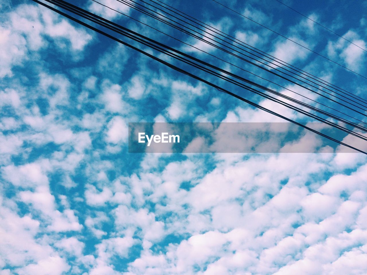 Low angle view of cables against blue sky