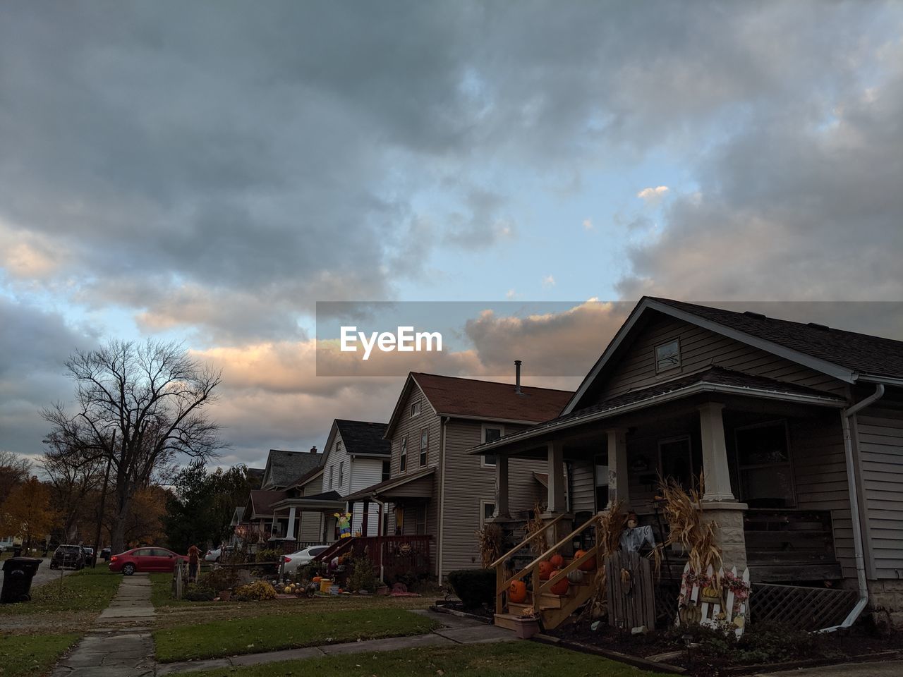 Houses and buildings against sky at sunset