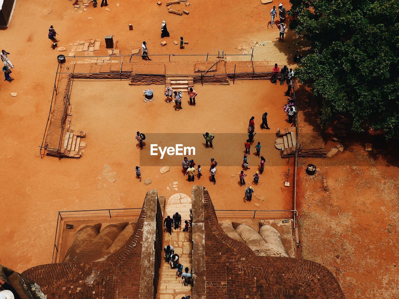 HIGH ANGLE VIEW OF PEOPLE WALKING ON STEPS AGAINST TREES