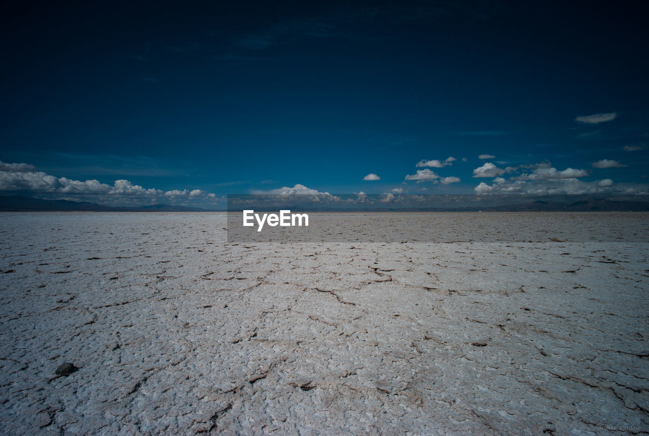 Scenic view of mountains against cloudy sky