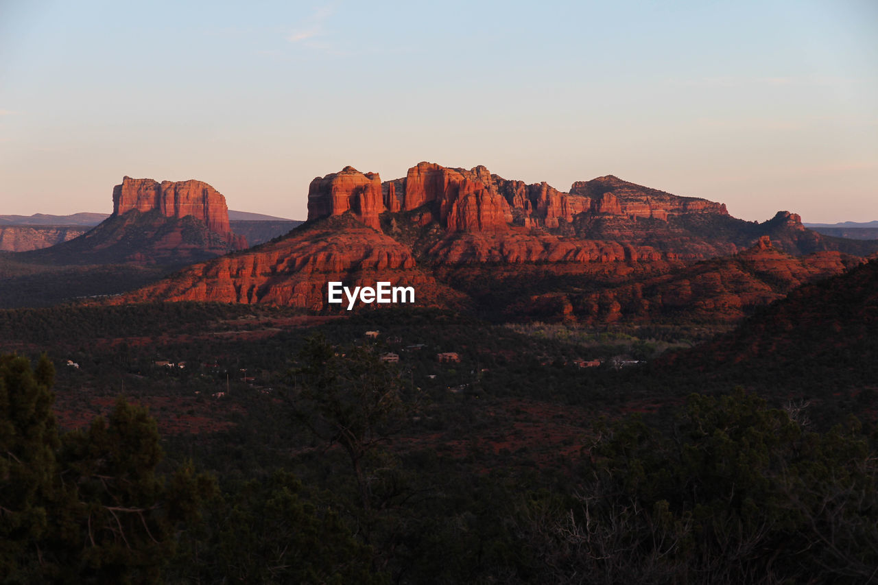 Scenic view of landscape against clear sky during sunset