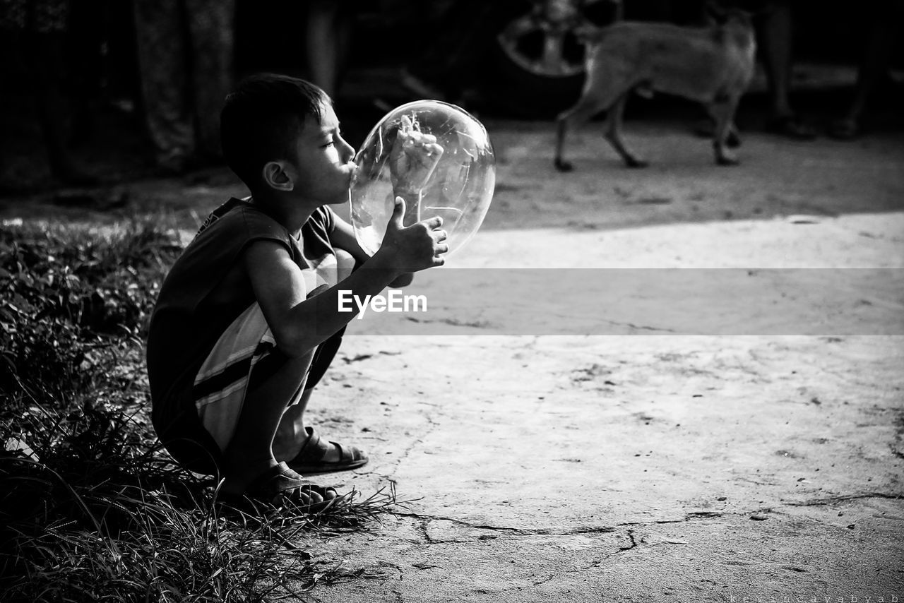 FULL LENGTH OF BOY PLAYING WITH HORSE ON FIELD