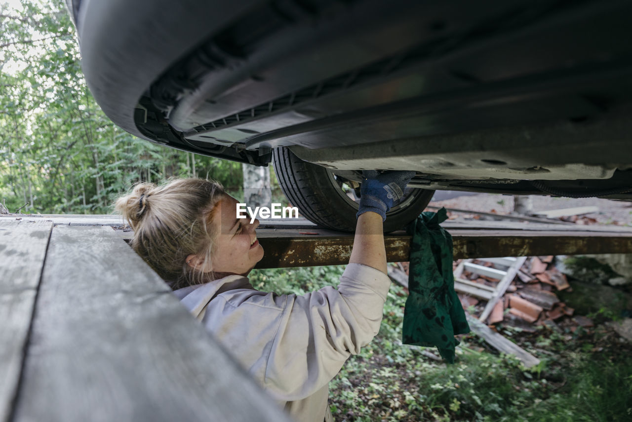 Woman repairing car
