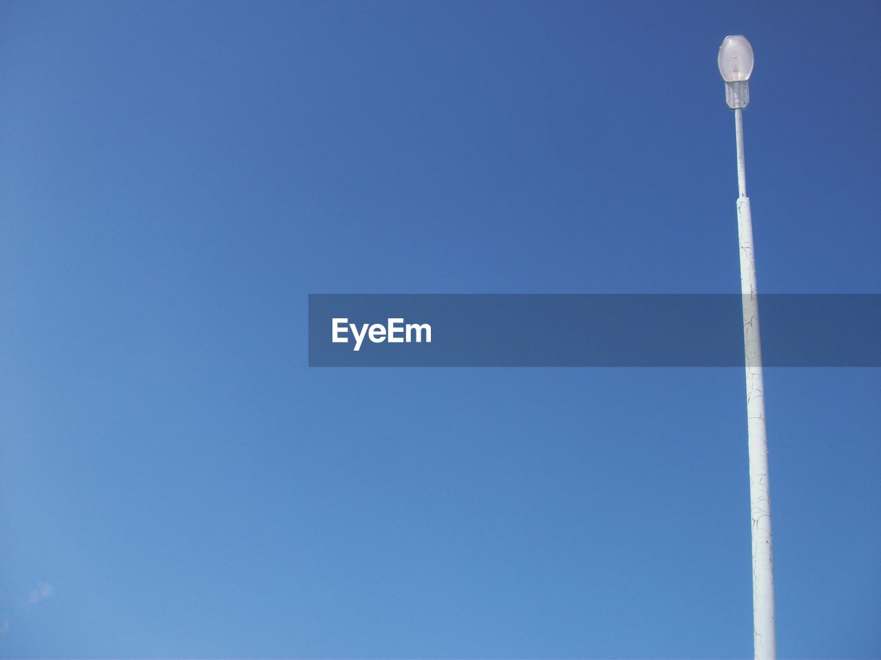 Low angle view of street light against clear blue sky