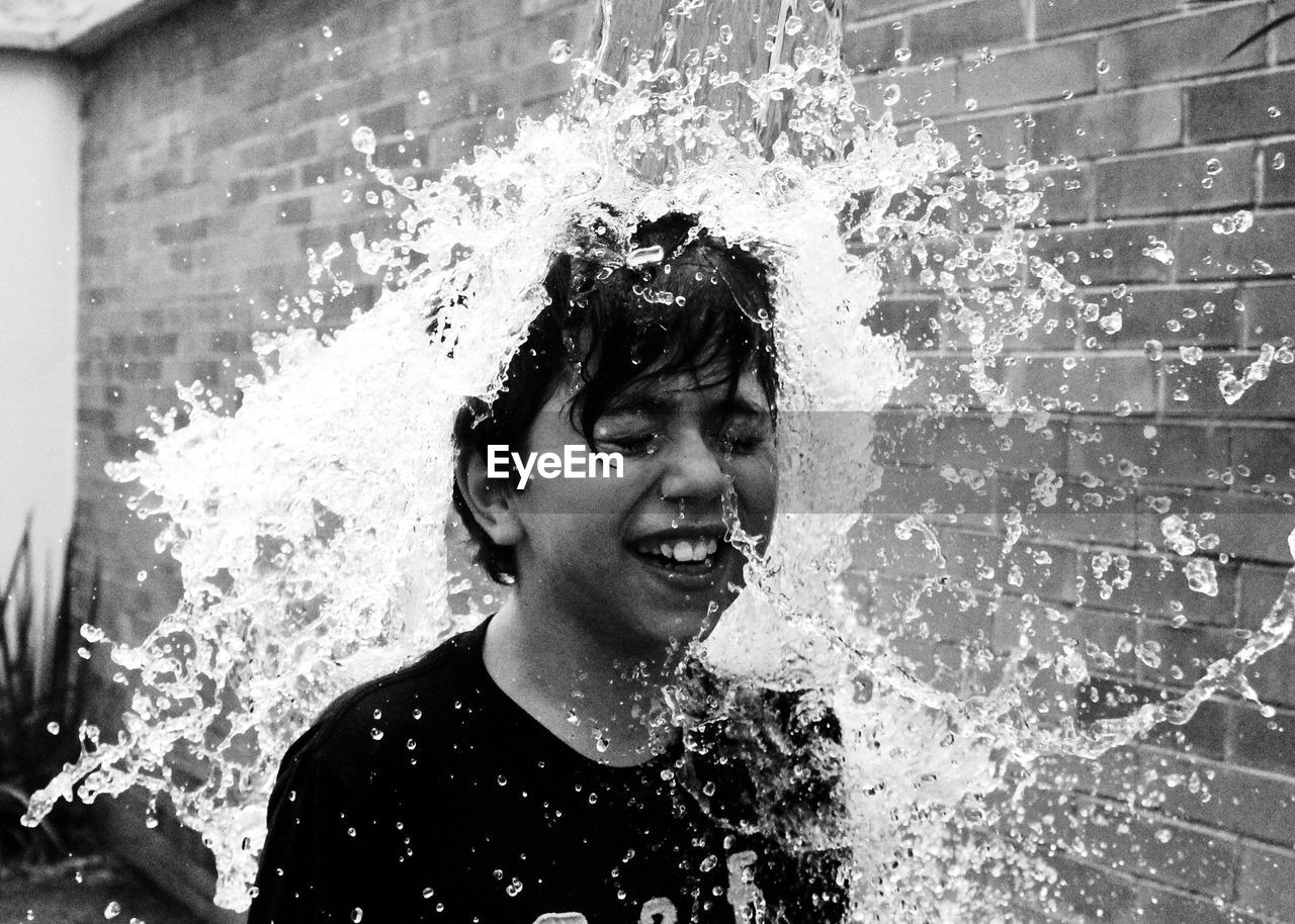 Boy being splashed with water