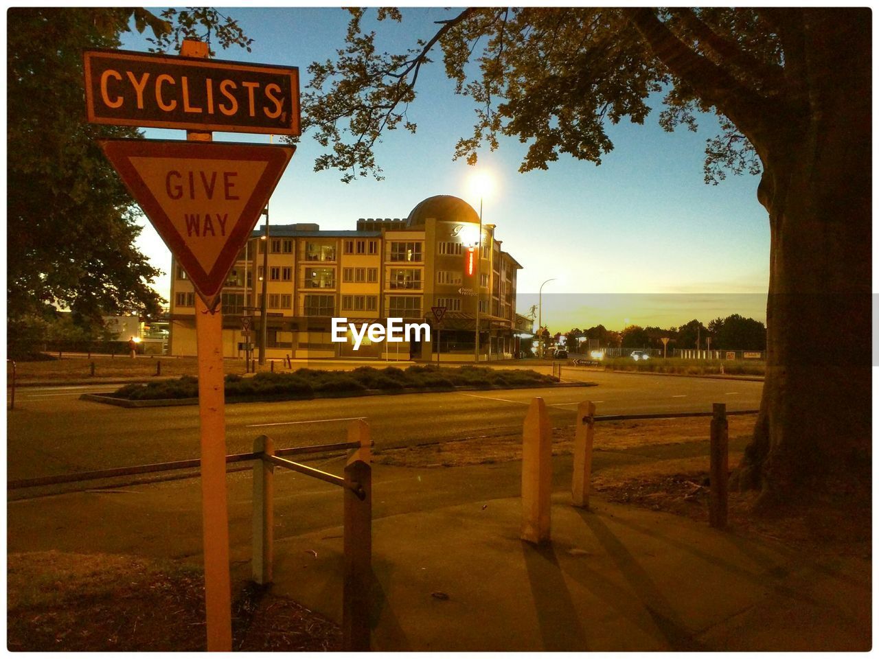 Sign board on street during sunset