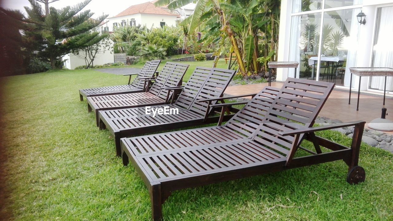 EMPTY CHAIRS AND TABLE IN YARD