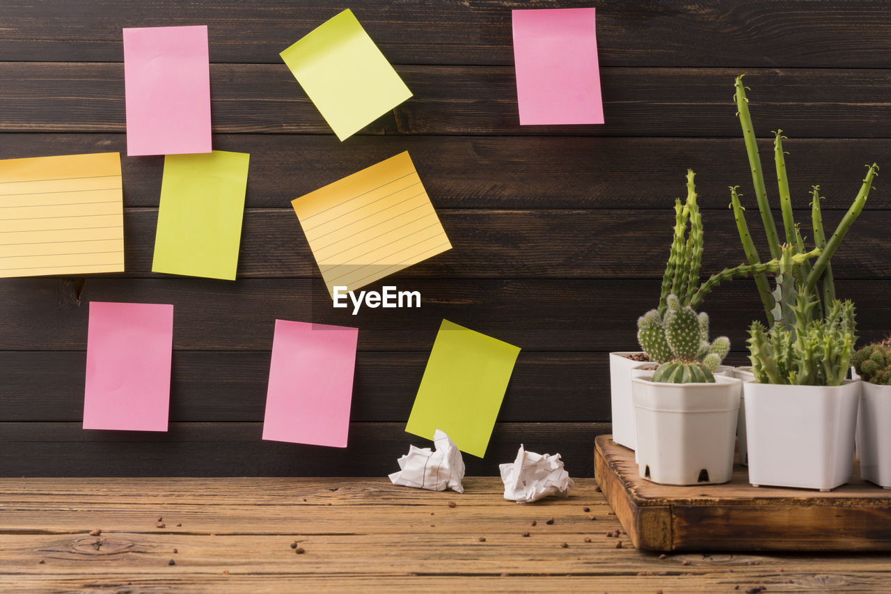 Colored paper reminder notes on a board or wooden background