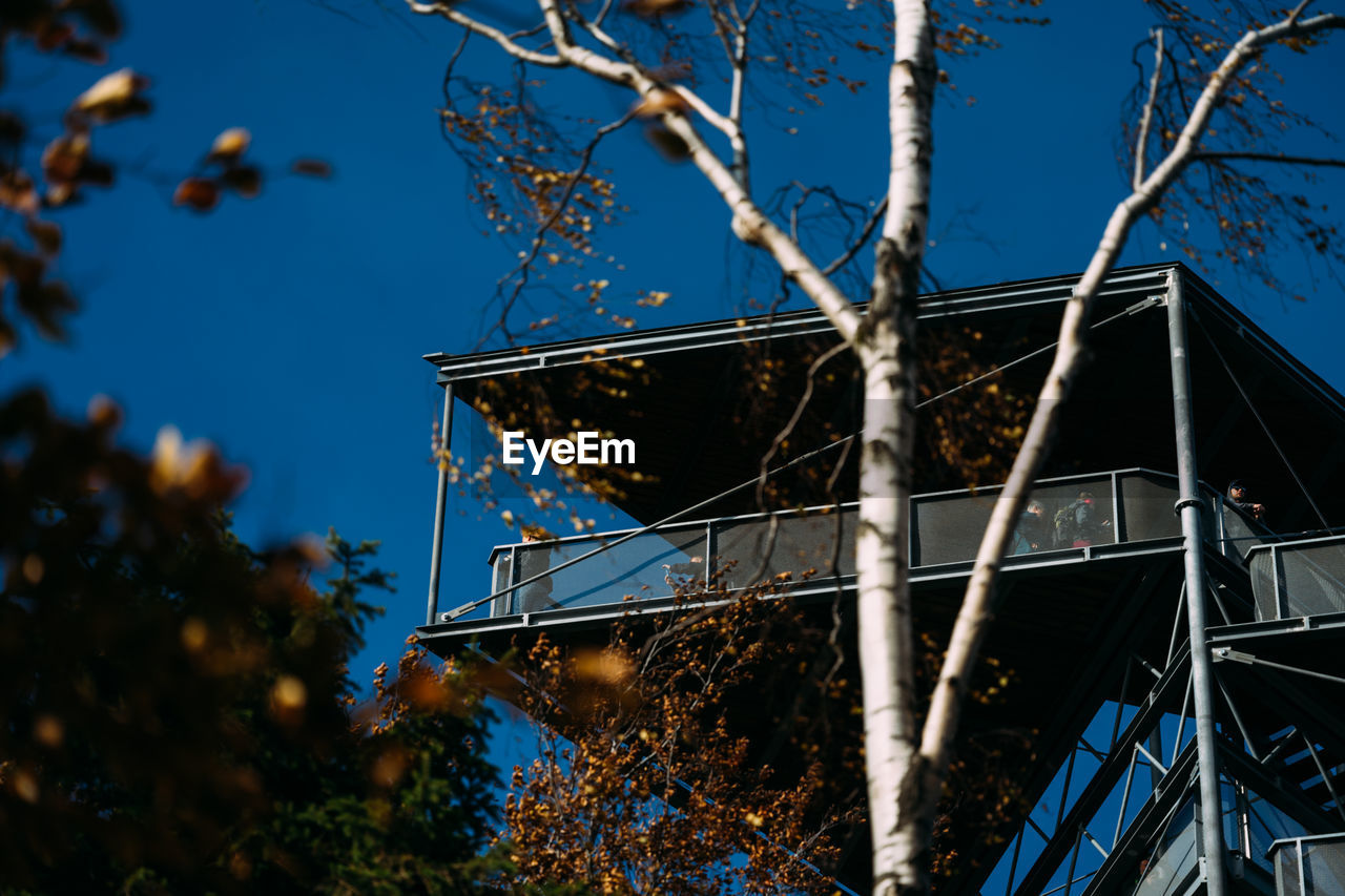 LOW ANGLE VIEW OF METAL STRUCTURE AGAINST BLUE SKY