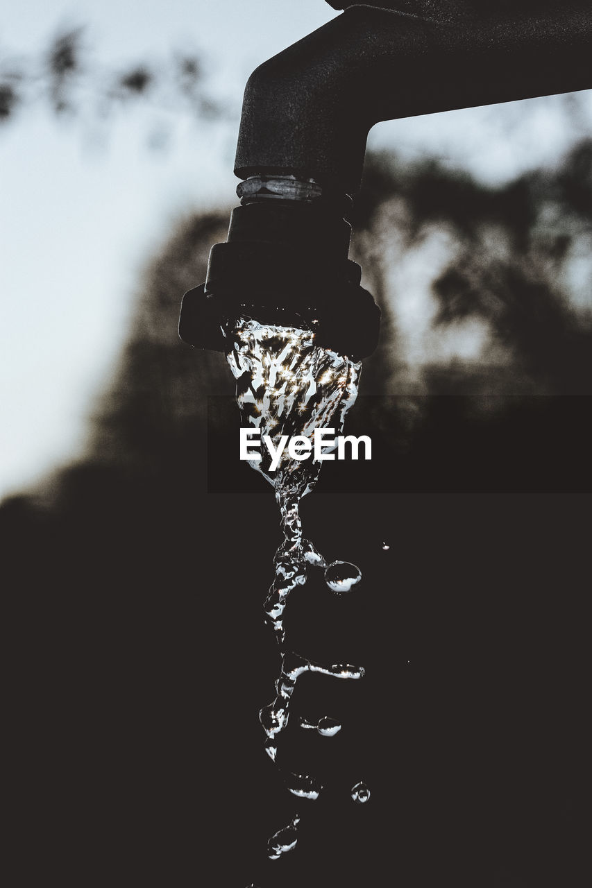 Close-up of water falling from faucet