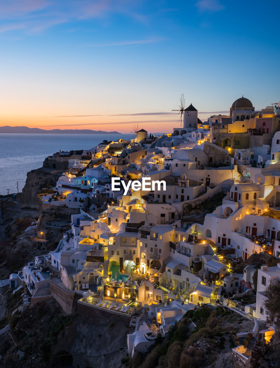 High angle view of townscape by sea against sky