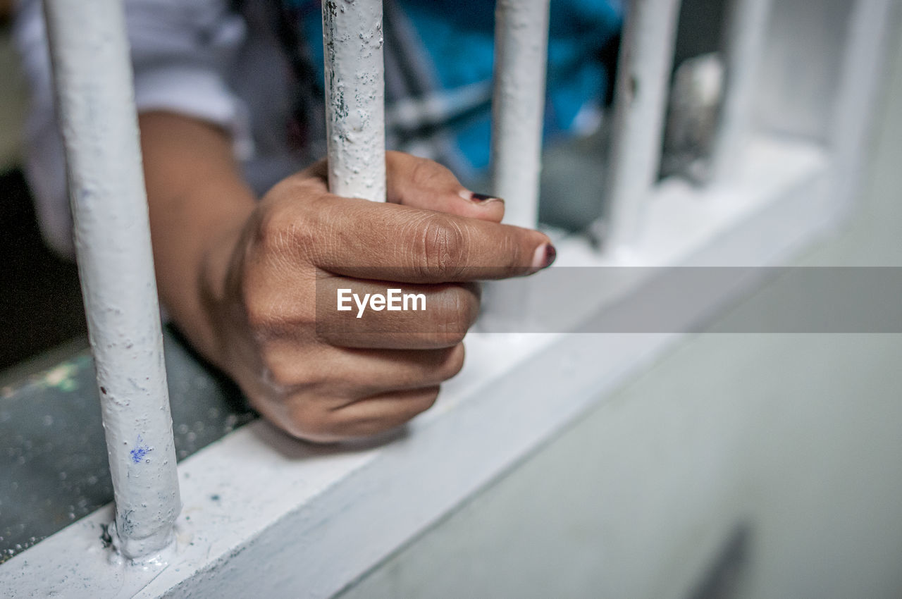 Hand close up of a man on a jail