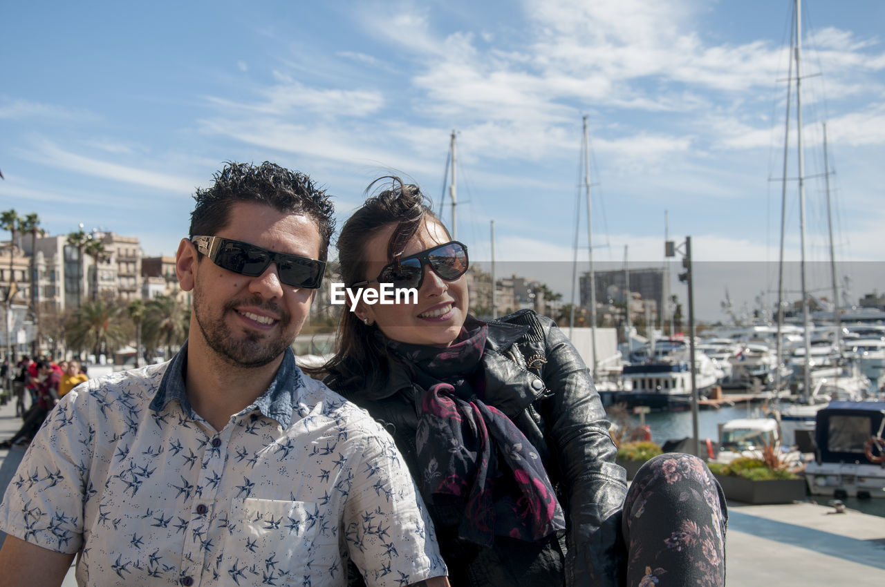 PORTRAIT OF SMILING MAN AGAINST SKY