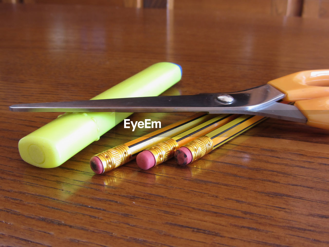 Close-up of pencils and scissors on table