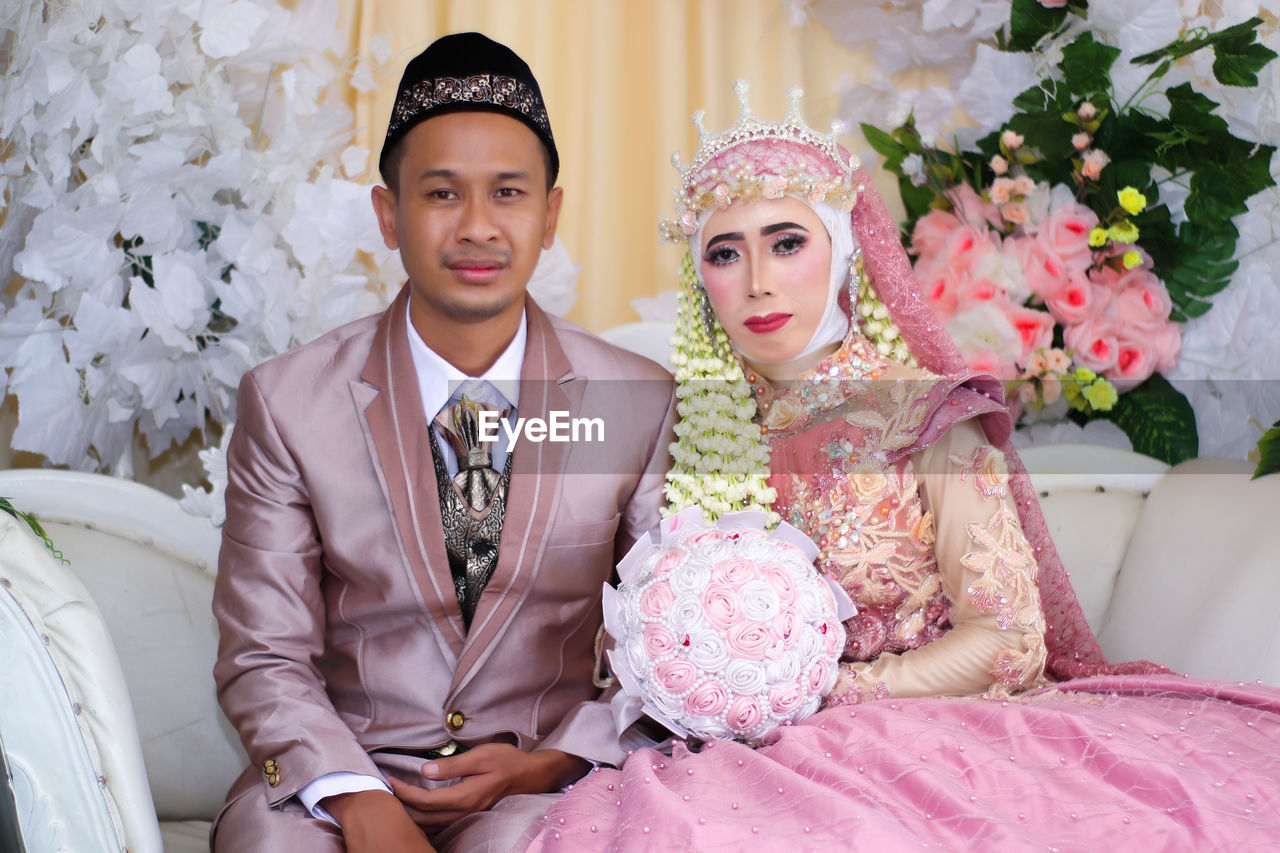 Portrait of young couple during wedding ceremony