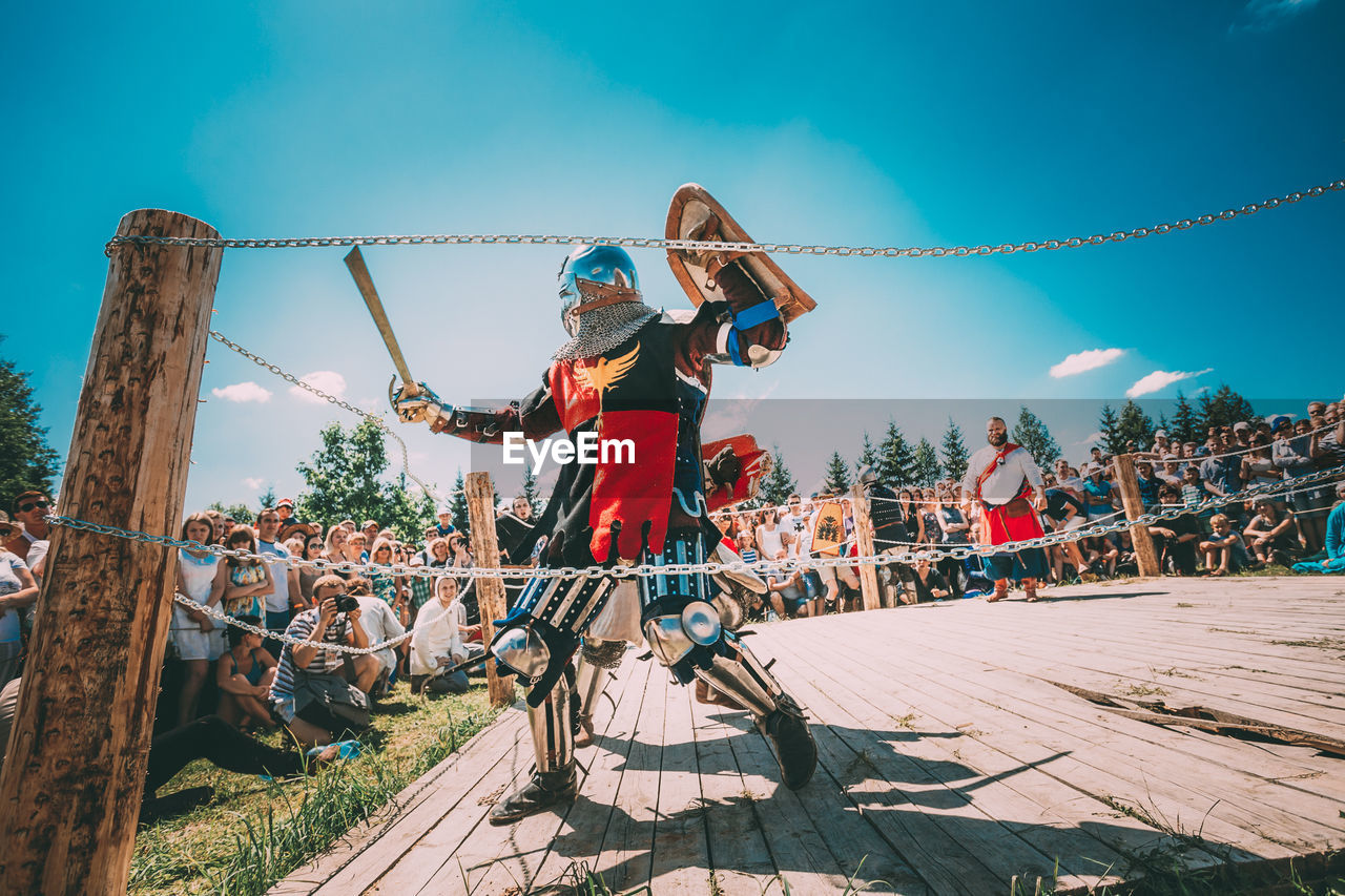 PEOPLE WITH FERRIS WHEEL IN BACKGROUND