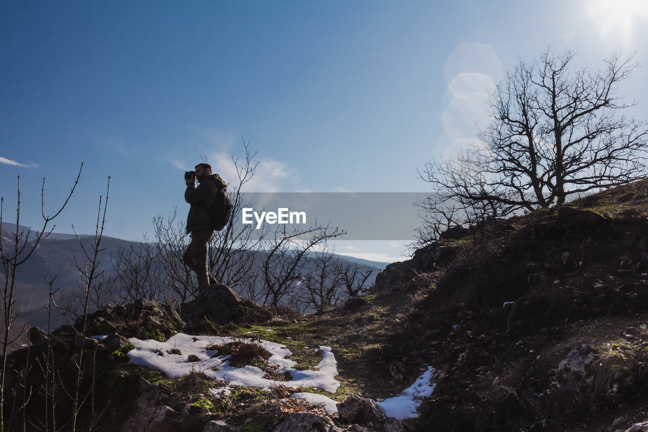 Man standing on mountains against sky