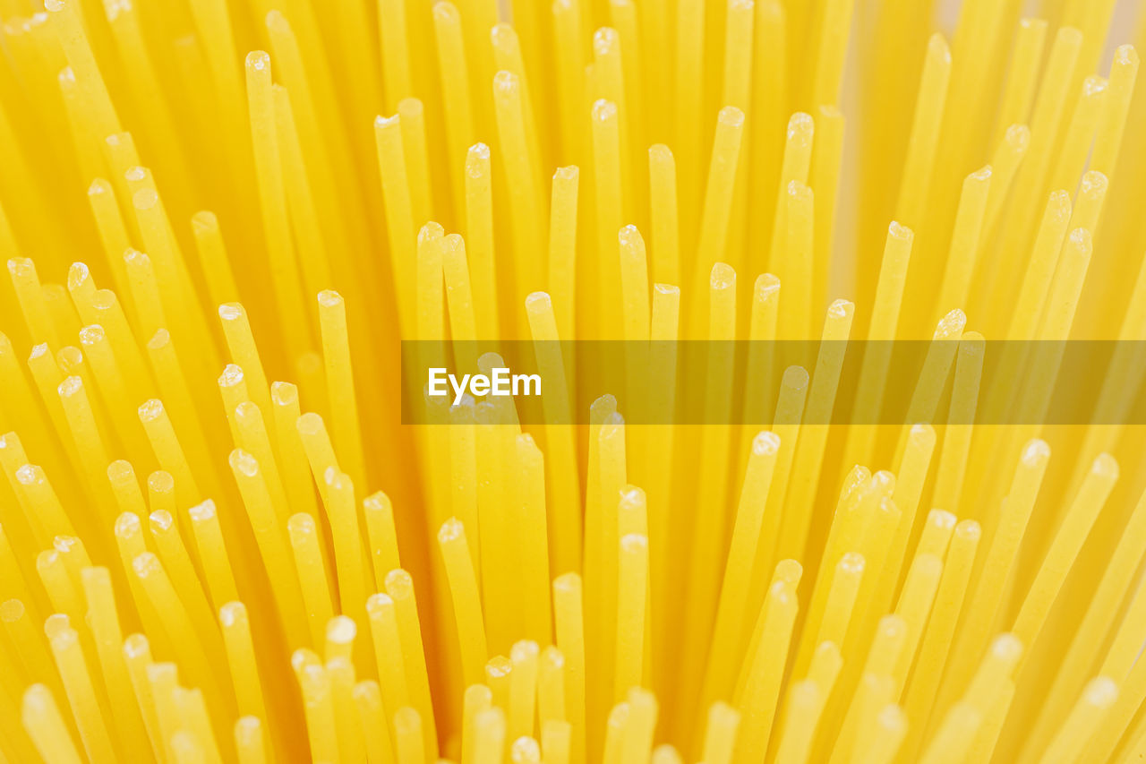 yellow, pasta, italian food, close-up, spaghetti, no people, sunlight, freshness, indoors, backgrounds, macro photography, abundance, large group of objects, still life, flower, raw food, drinking straw, food and drink, line