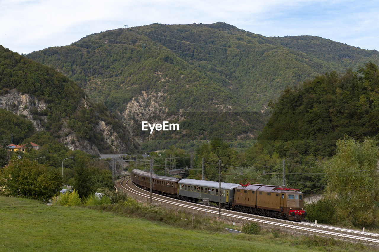 Train on railroad track by mountains