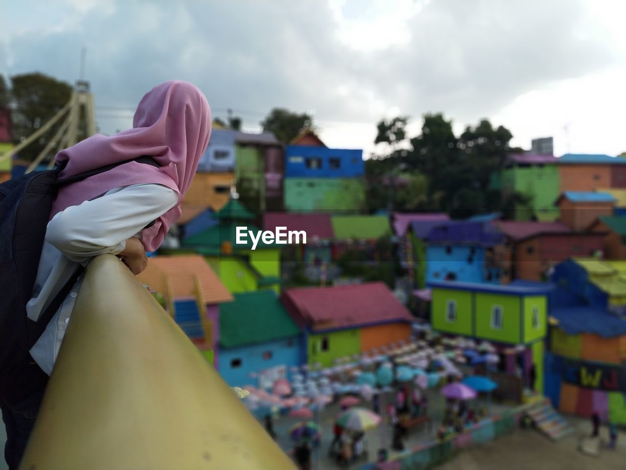 Woman looking at colorful houses in town