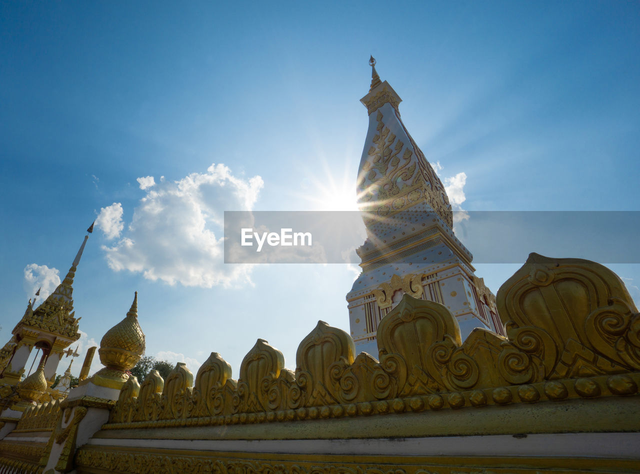 The pagoda of wat phra that panom temple in nakhon phanom in cloudy blue sky day with sunlight
