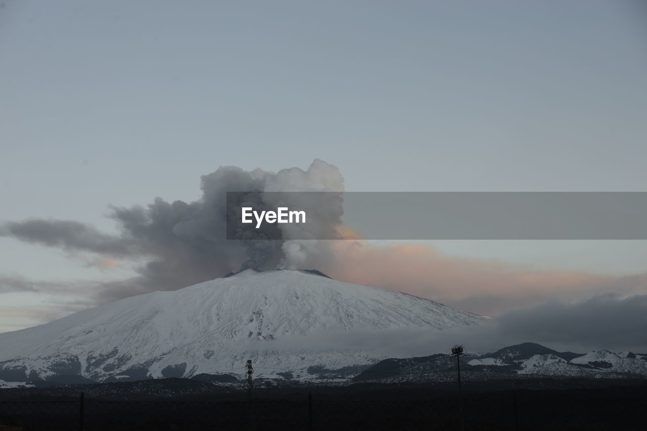 Scenic view of snowcapped mountains against sky etna eruption