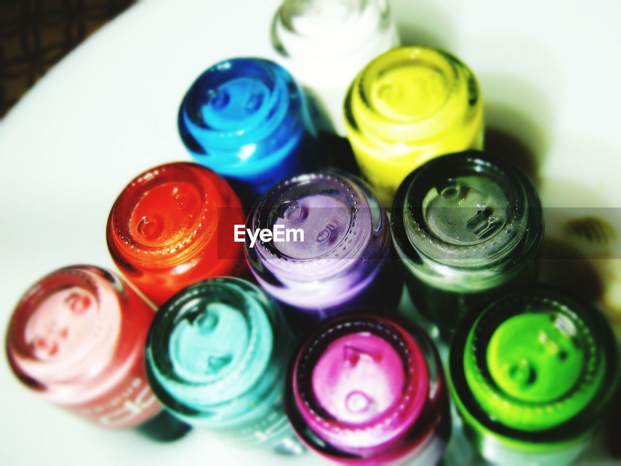 Close-up of upside down colorful nail polish bottles