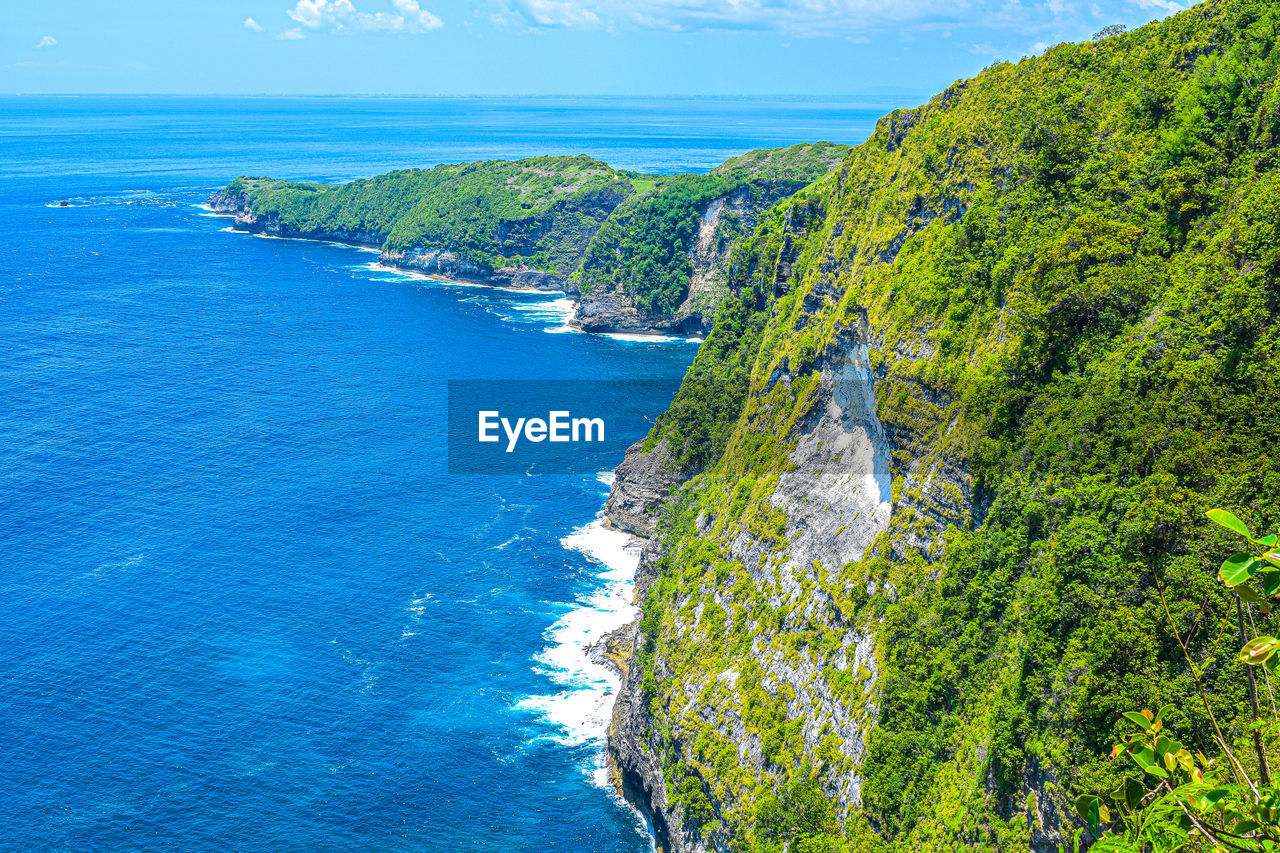 High angle view of sea against blue sky