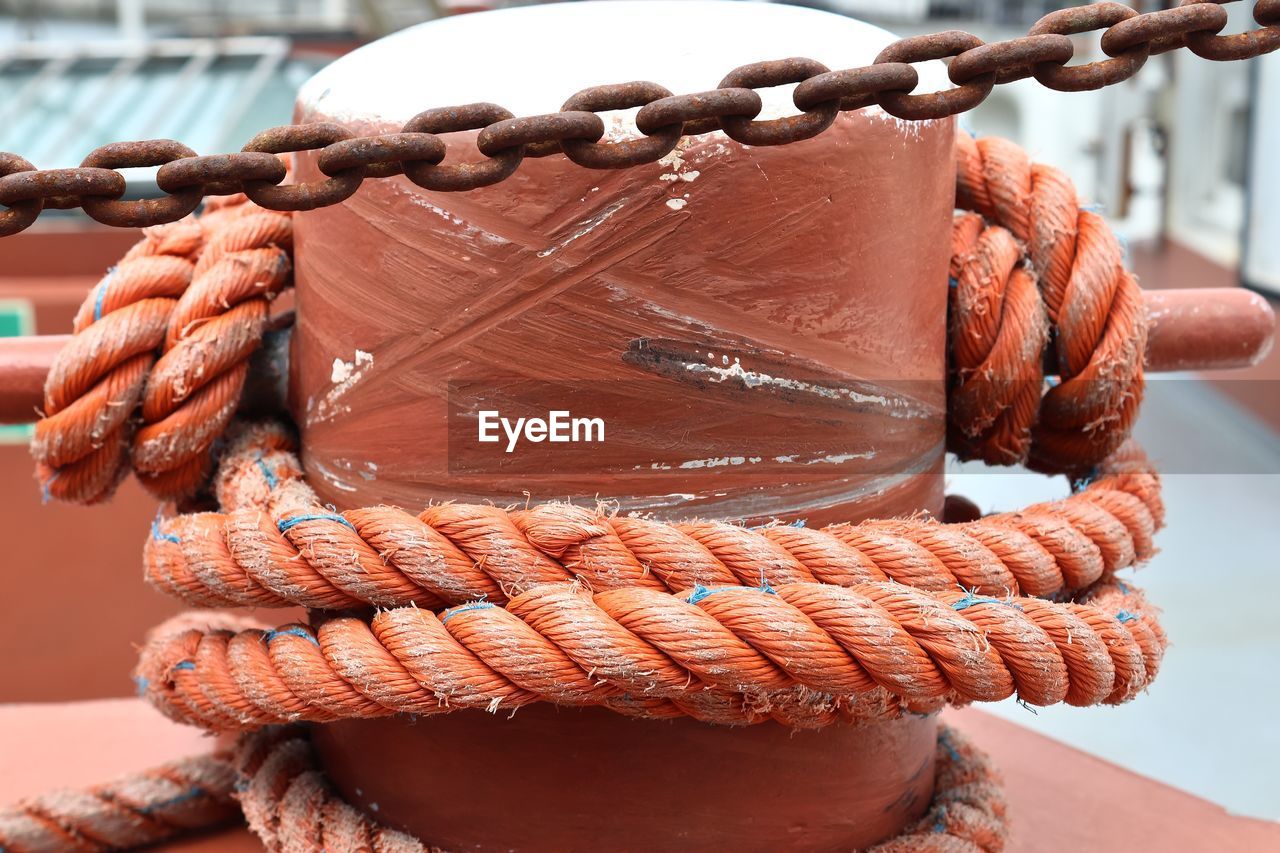 Close-up of rope tied on metallic bollard