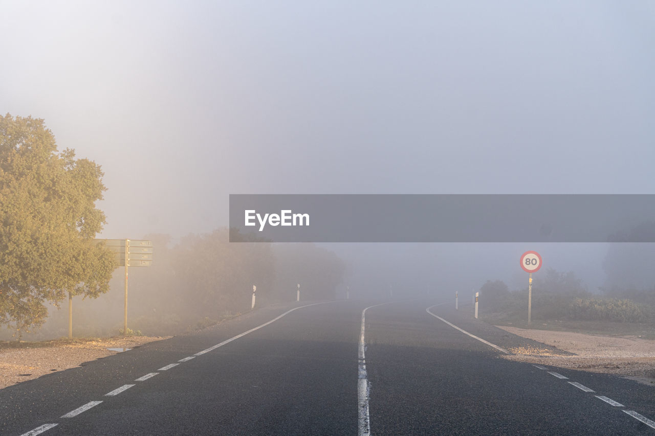 Empty road with fog at sunrise.