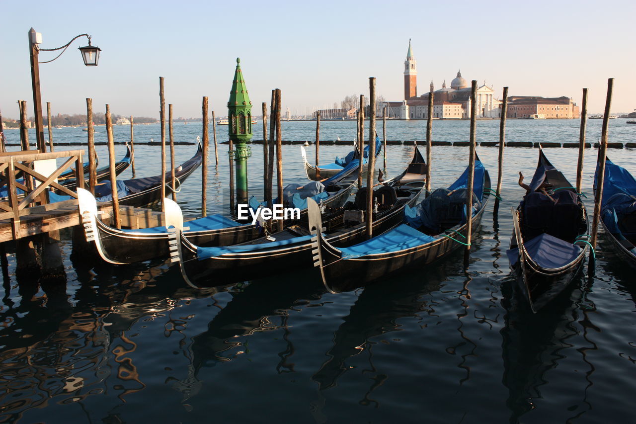 Gondolas moored on shore