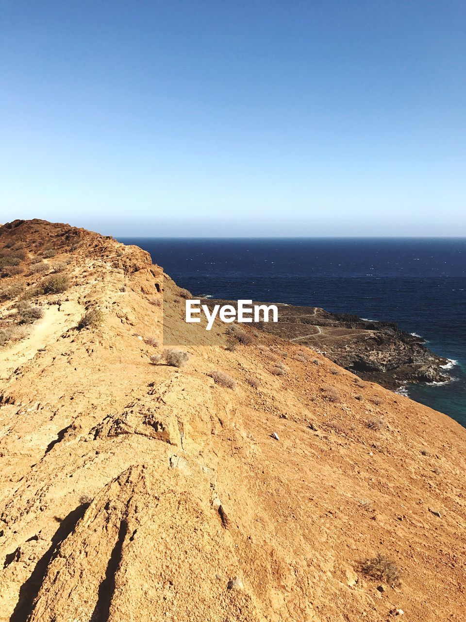 Scenic view of sea against clear blue sky