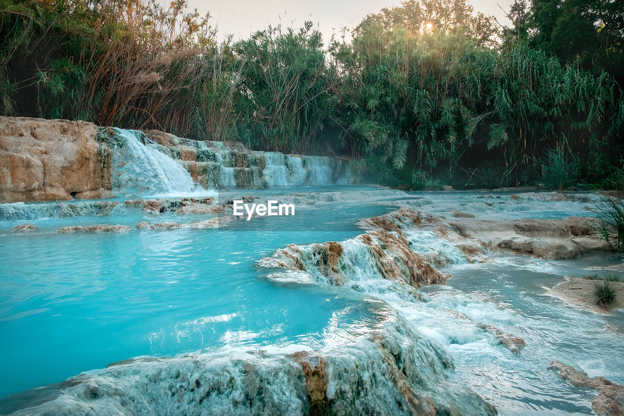 Scenic view of river flowing through rocks