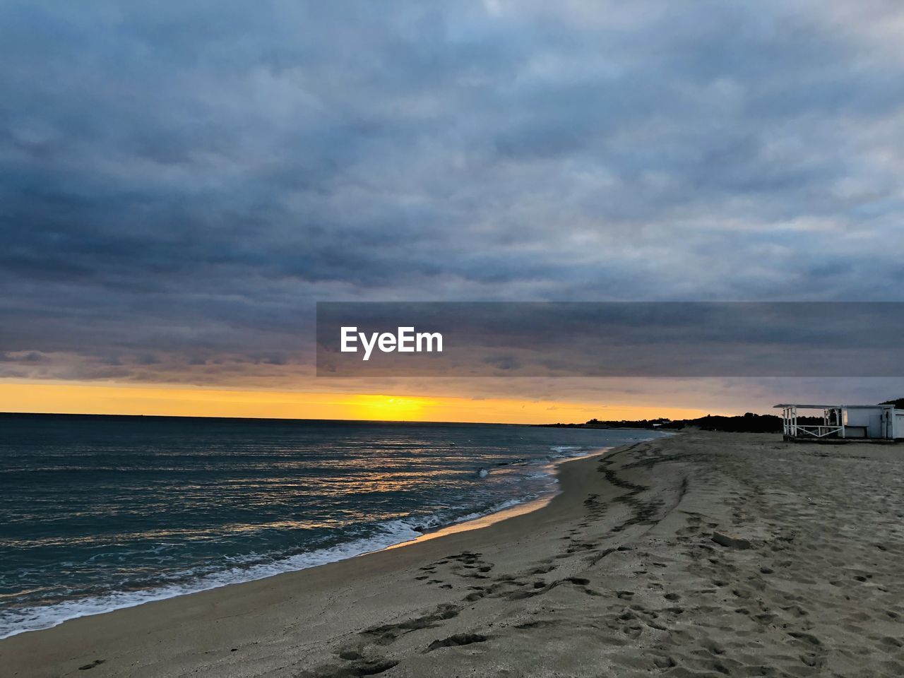 SCENIC VIEW OF BEACH DURING SUNSET